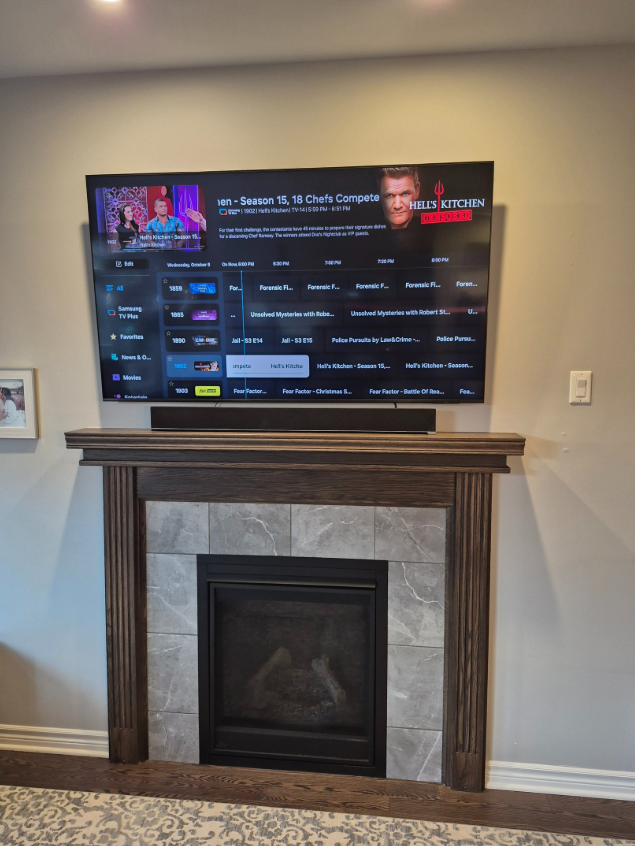 TV above fireplace with mantle, professionally mounted in Ottawa