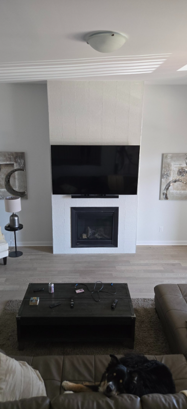 TV mounted above a white fireplace in Ottawa